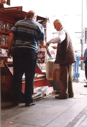 man-buying-papers